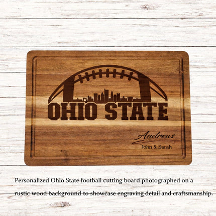 Personalized Ohio State football cutting board engraved in dark brown on solid acacia wood, featuring skyline design and custom family name