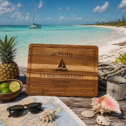 Acklins Bahamas sailboat cutting board displayed beside shallow turquoise banks and isolated tropical shoreline in the southern Bahamas