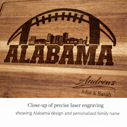 Close-up of natural dark brown laser engraving on personalized Alabama football acacia wood cutting board showing city skyline and family name