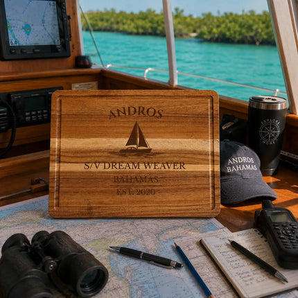 Andros Bahamas sailboat cutting board displayed inside a cruising sailboat navigation area with charts gear and remote tropical exploration atmosphere