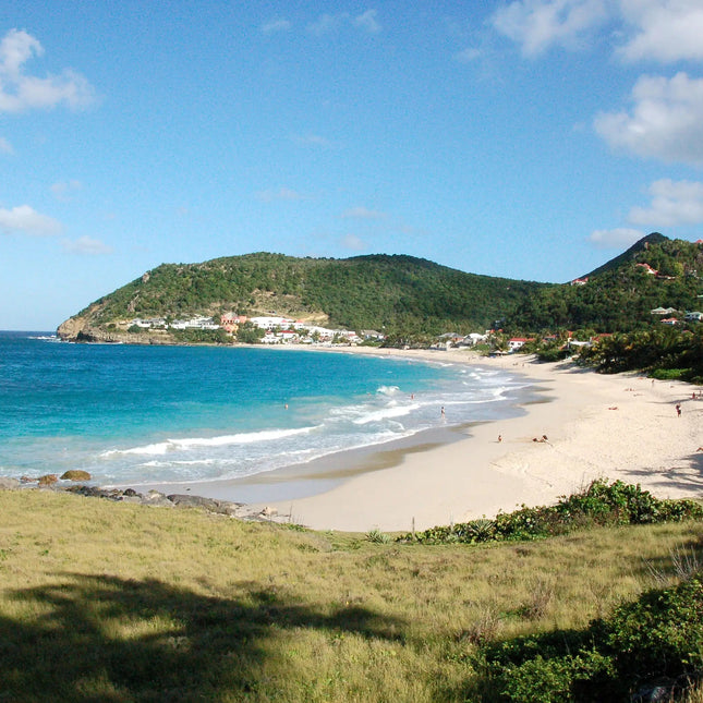 Secluded white sand beach at Anse de Colombier in St. Barths, accessible primarily by boat or hiking trail and surrounded by protected natural scenery.
