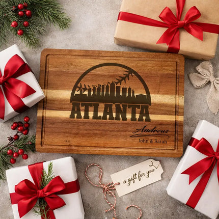 Personalized Atlanta baseball cutting board presented as a gift with wrapped boxes ribbon and decorative elements