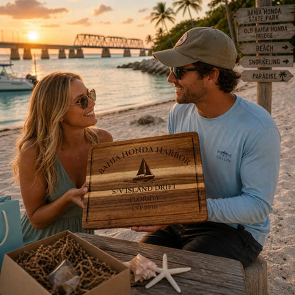 Bahia Honda Harbor Florida personalized cutting board being given as a gift on a tropical dock at sunset with palm trees and calm water