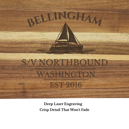 Close up of Bellingham Washington sailboat cutting board engraving showing detailed sailboat design and clean acacia wood grain