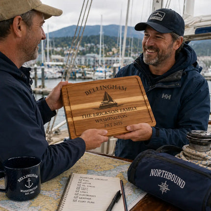 Bellingham Washington personalized cutting board being given as a gift between sailors at the marina with boats and mountains in the background