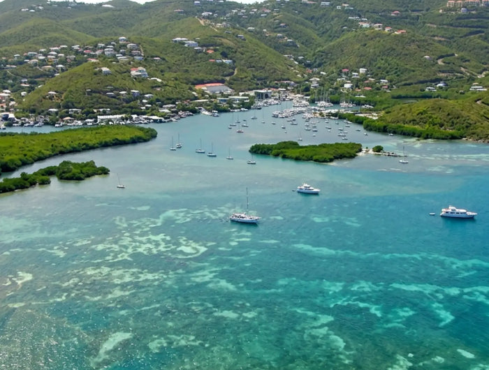 Aerial overview of Benner Bay Harbor showing the protected lagoon, mangroves, marinas, and surrounding hills on the east end of St. Thomas, U.S. Virgin Islands.