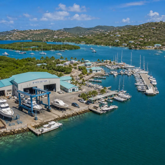Compass Point Marina and marine service facilities at Benner Bay Harbor with docks, haul-out equipment, and cruising yachts.