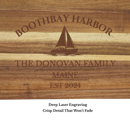 Close up engraving detail of Boothbay Harbor Maine sailboat cutting board showing custom boat name and harbor engraving
