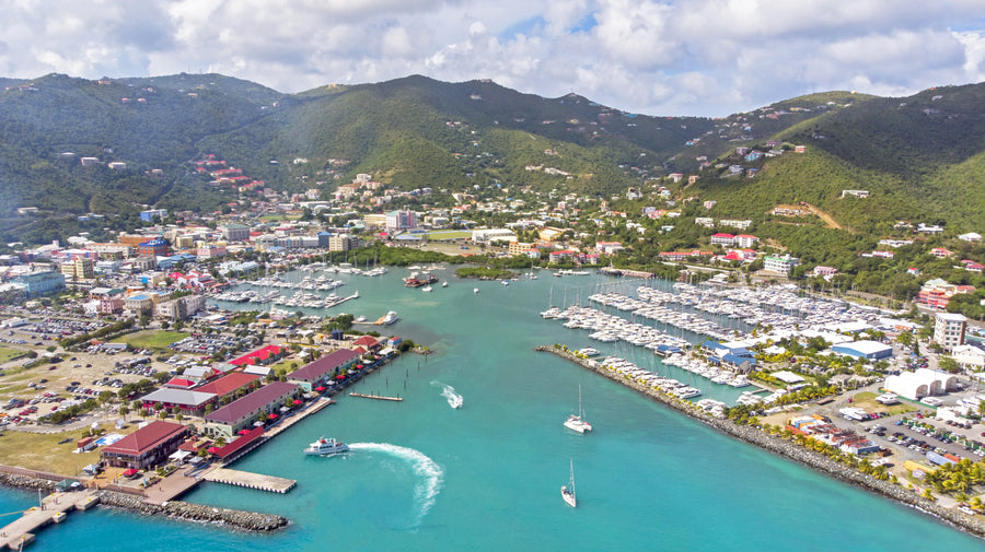Aerial view of Road Town Harbor on Tortola in the British Virgin Islands, featuring marinas, sailboats, and one of the Caribbean's premier cruising destinations.