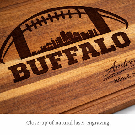 Close-up of natural dark brown laser engraving on personalized Buffalo football acacia wood cutting board showing skyline football design and custom name