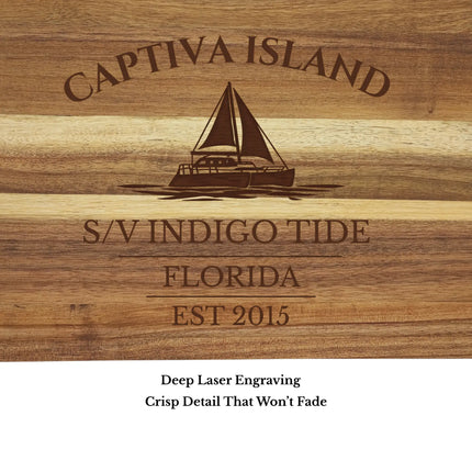 Close up of Captiva Island Florida sailboat cutting board engraving showing detailed sailboat design and acacia wood grain