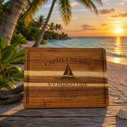 Captiva Island Florida sailboat cutting board on a beachside table with palm trees soft sand and warm Gulf Coast sunset background
