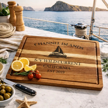 Channel Islands California sailboat cutting board displayed on boat galley with ocean view and coastal ingredients