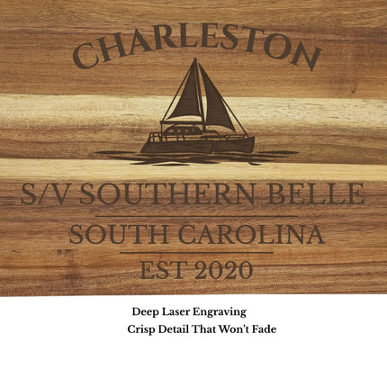 Close up of Charleston sailboat engraving on acacia wood cutting board showing detailed laser engraving quality