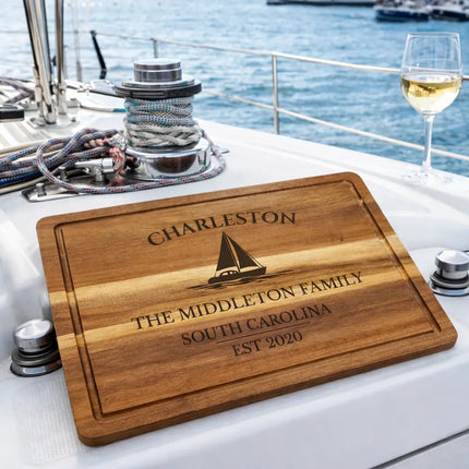 Charleston personalized cutting board displayed on a sailboat deck with ocean view and nautical setting