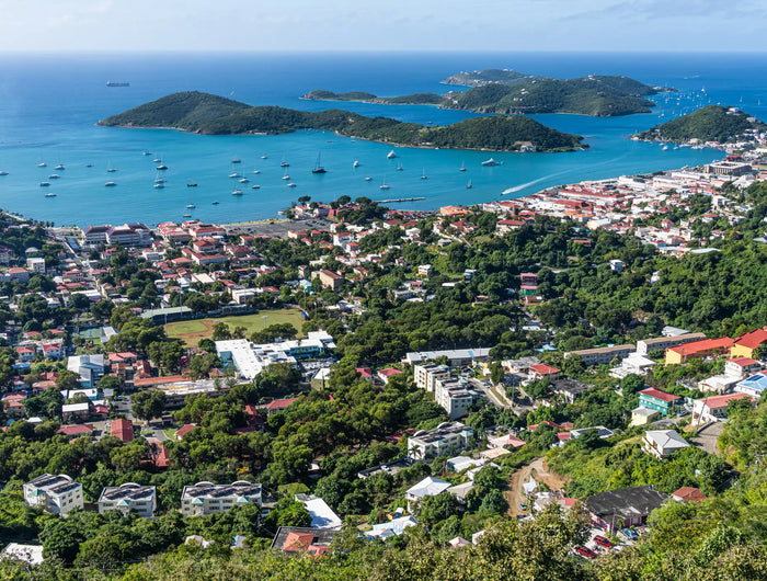 Aerial view of Charlotte Amalie Harbor in St. Thomas, U.S. Virgin Islands, showing the protected harbor, waterfront, and surrounding tropical hills.