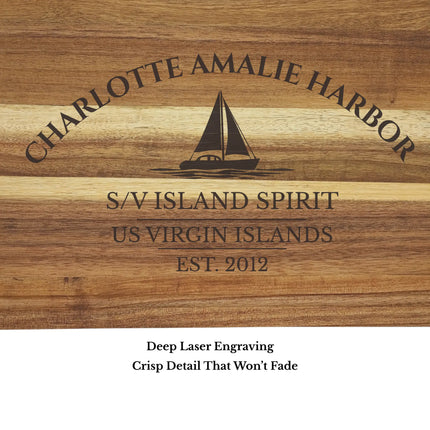 Close up of Charlotte Amalie Harbor US Virgin Islands sailboat cutting board engraving showing detailed sailboat design and acacia wood grain