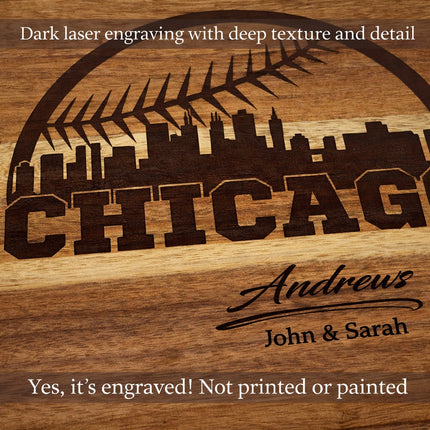 Close-up of dark laser engraved Chicago baseball skyline and personalized family name carved into solid acacia wood cutting board
