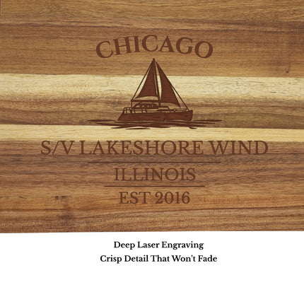 Close up engraving detail of Chicago Illinois sailboat cutting board showing precision laser engraved sailboat design on acacia wood