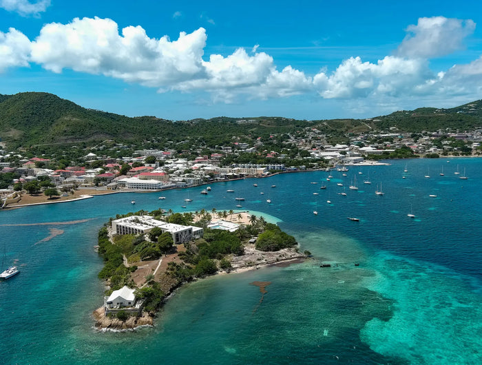 Aerial view of Christiansted Harbor on St. Croix, U.S. Virgin Islands, featuring Protestant Cay, anchored sailboats, turquoise Caribbean waters, and the historic waterfront.
