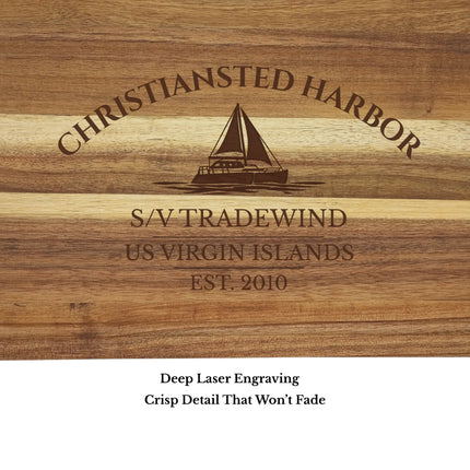 Close up of Christiansted Harbor US Virgin Islands sailboat cutting board engraving showing detailed sailboat design and acacia wood grain