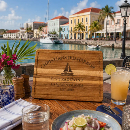Christiansted Harbor US Virgin Islands sailboat cutting board displayed beside colorful historic Caribbean waterfront buildings and anchored sailboats on St Croix