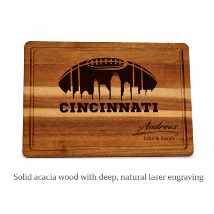 Cincinnati football cutting board on white background showing solid acacia wood with deep natural laser engraving and personalized name