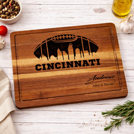Cincinnati football cutting board styled on kitchen counter with food, personalized acacia wood board for entertaining and game day