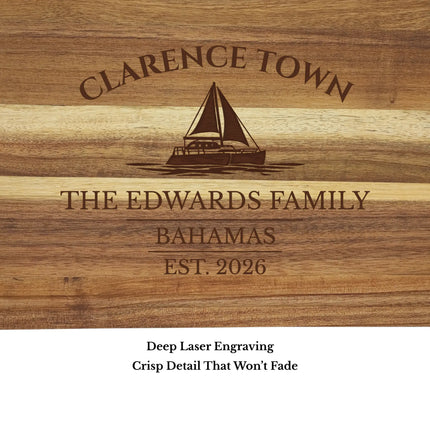 Close up of Clarence Town Bahamas sailboat cutting board engraving showing detailed sailboat design and acacia wood grain