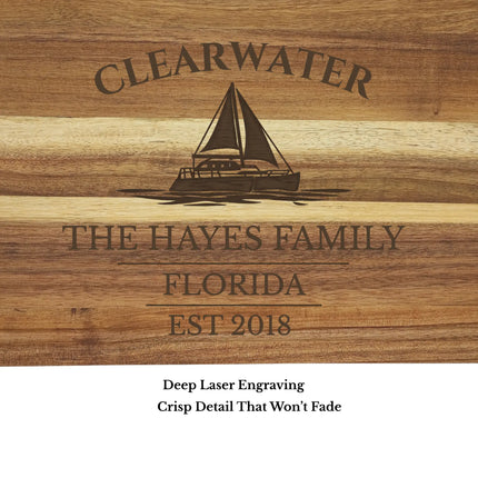 close up of personalized clearwater sailboat cutting board engraving detail on acacia wood boat name and harbor