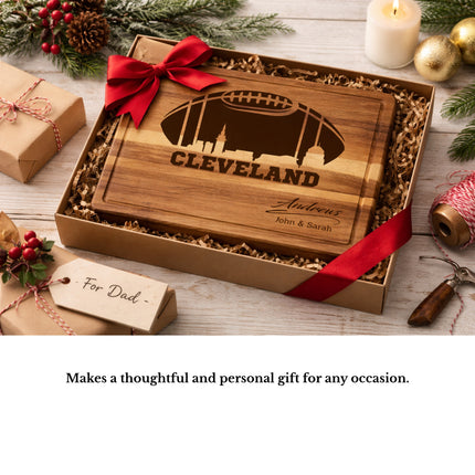 Personalized Cleveland football cutting board displayed as a gift with ribbon and holiday decorations