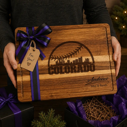 Personalized Colorado baseball cutting board presented as a gift with purple and black ribbon and wrapped boxes