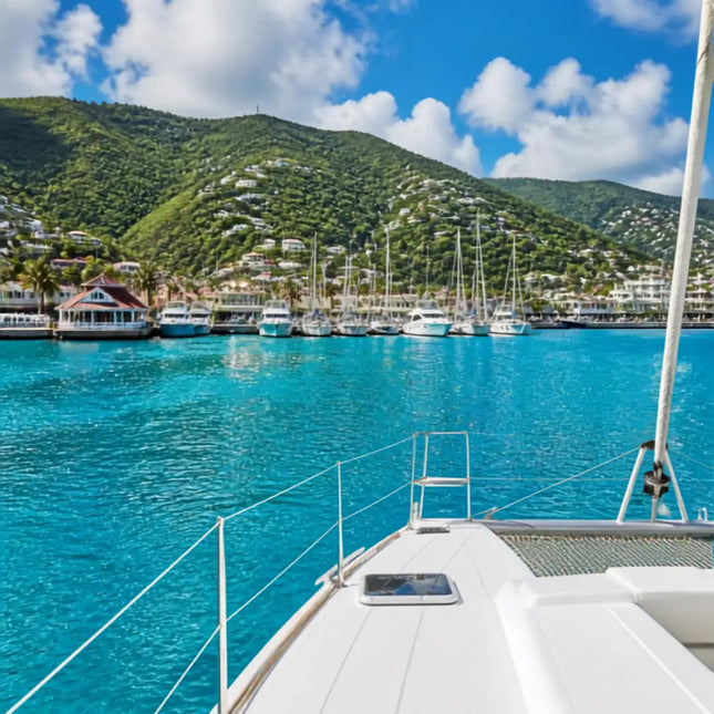 View approaching Crown Bay Harbor from offshore with a cruising sailboat and the marina ahead on St. Thomas in the U.S. Virgin Islands.