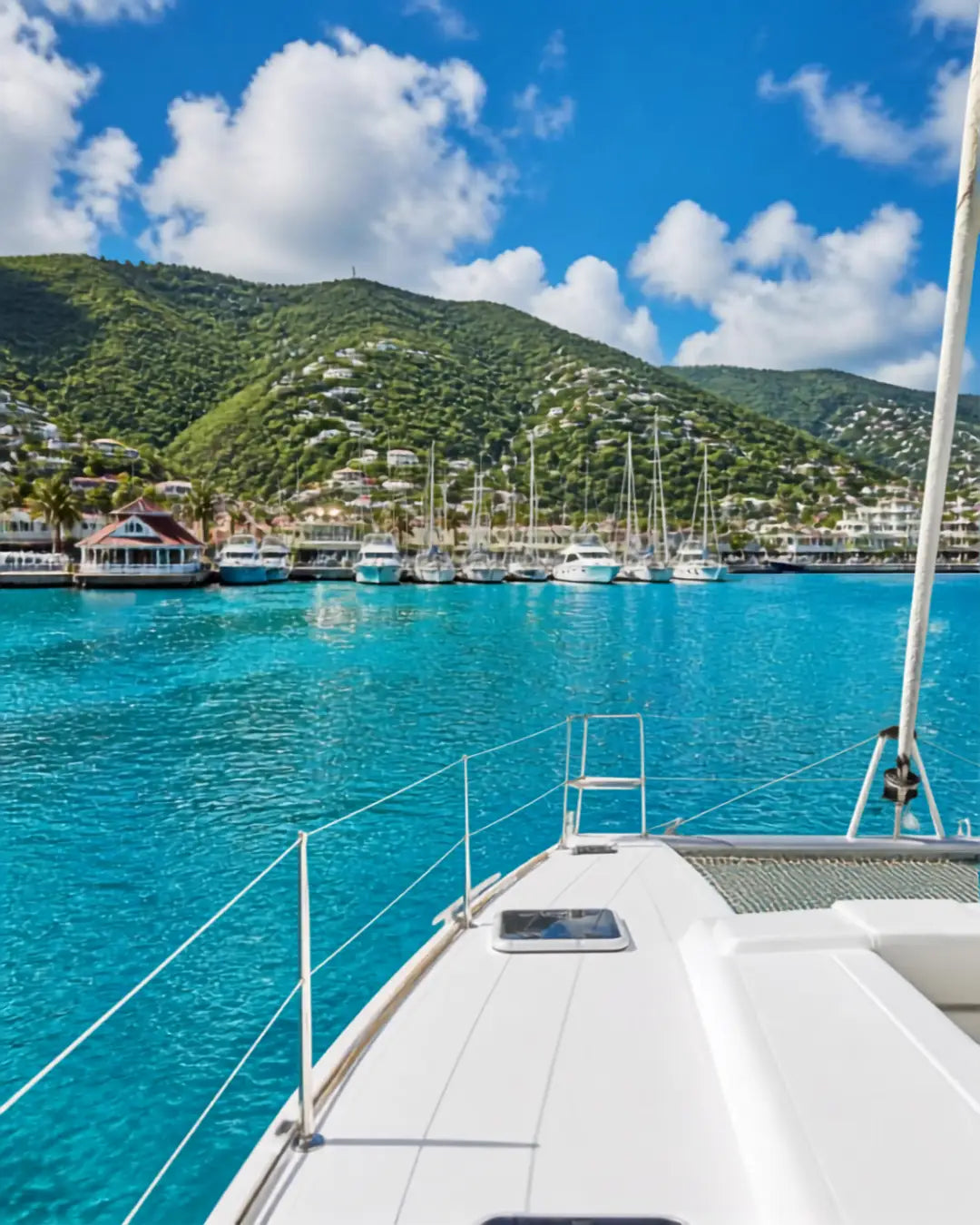 View approaching Crown Bay Harbor from offshore with a cruising sailboat and the marina ahead on St. Thomas in the U.S. Virgin Islands.