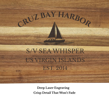 Close up of Cruz Bay Harbor US Virgin Islands sailboat cutting board engraving showing detailed sailboat design and acacia wood grain