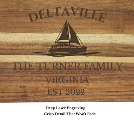 Close up of Deltaville Virginia sailboat engraving on acacia wood cutting board showing detailed laser engraving