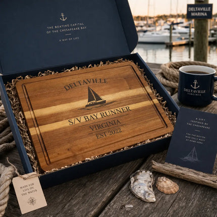 Deltaville Virginia sailboat cutting board presented in coastal gift box with rope nautical elements and marina inspired setting