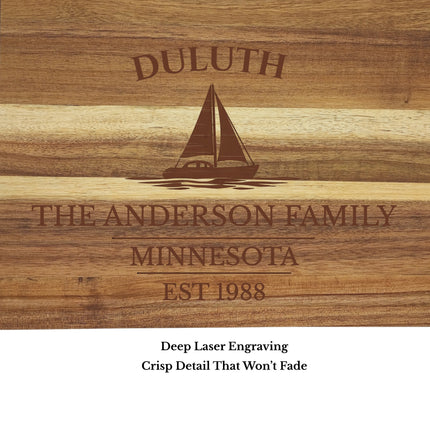 Close up of Duluth Minnesota sailboat cutting board engraving showing detailed sailboat design on solid acacia wood