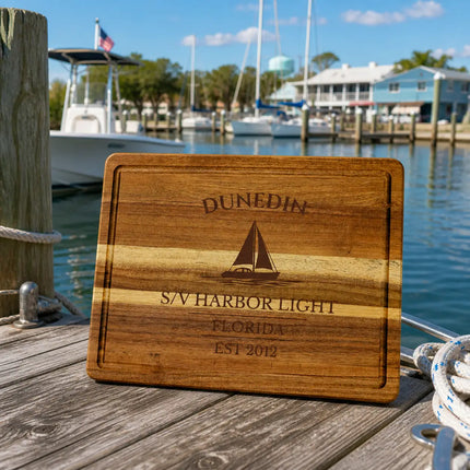 Dunedin Florida sailboat cutting board on a wooden dock at a small marina with calm water and modest boats in daylight