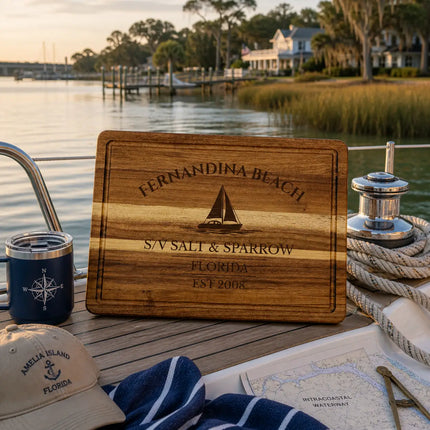 Fernandina Beach Florida sailboat cutting board on a boat deck overlooking marsh grass and calm intracoastal waterway at golden hour