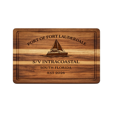 Personalized Fort Lauderdale sailboat cutting board engraved with a catamaran design, custom boat name S/V Intracoastal, South Florida home port, and established year on solid acacia wood.