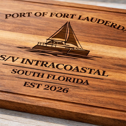 Close-up detail of engraved sailboat cutting board showing deep laser engraving, rich acacia wood grain, and 1-inch thick edge for a personalized Fort Lauderdale nautical gift