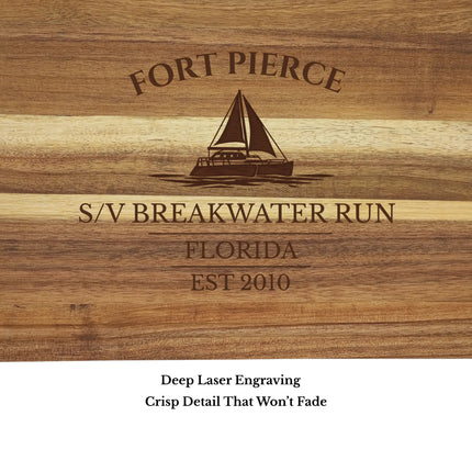 Close up of Fort Pierce Florida sailboat cutting board engraving showing detailed sailboat design and acacia wood grain
