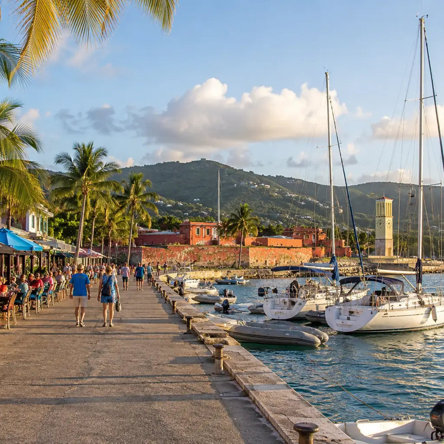 Lively Frederiksted waterfront featuring cafés, palm trees, sailboats, dinghies, pedestrians, and Fort Frederik along the scenic harbor in St. Croix, U.S. Virgin Islands.