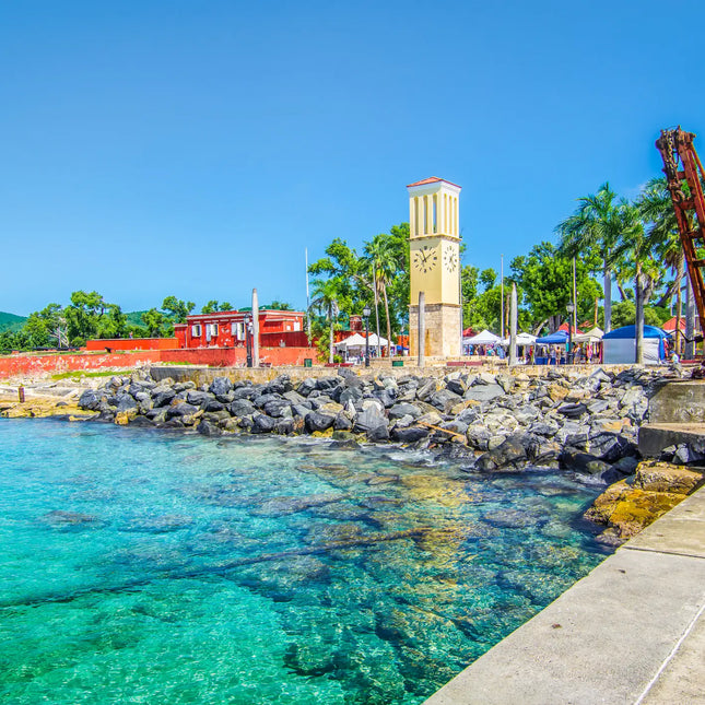 Historic waterfront in Frederiksted, St. Croix, U.S. Virgin Islands, featuring Fort Frederik, the waterfront clock tower, crystal-clear Caribbean waters, and the palm-lined promenade.