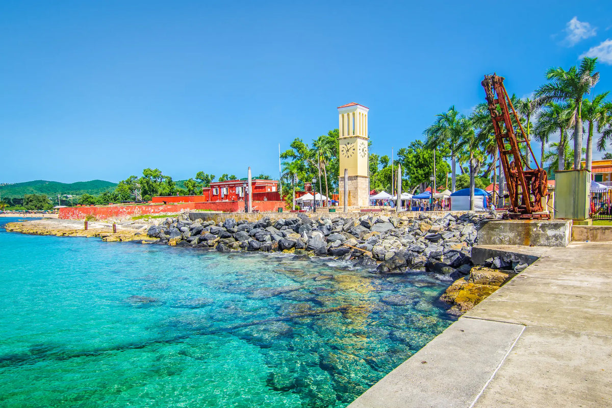 Historic waterfront in Frederiksted, St. Croix, U.S. Virgin Islands, featuring Fort Frederik, the waterfront clock tower, crystal-clear Caribbean waters, and the palm-lined promenade.