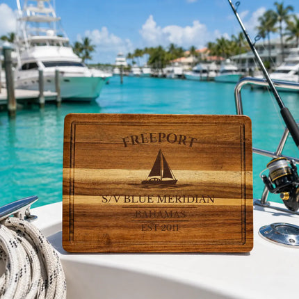 Freeport Bahamas sailboat cutting board on a yacht deck overlooking turquoise Caribbean marina water and tropical boating scenery