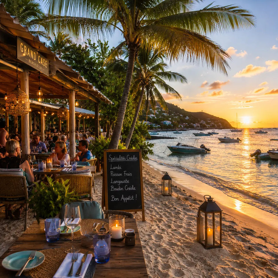 Beachfront waterfront dining scene in the French Caribbean featuring outdoor restaurants, anchored boats, and a relaxed sailing destination atmosphere at sunset