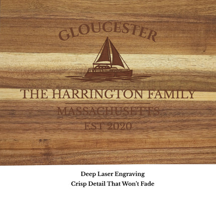 close up engraving detail Gloucester Massachusetts sailboat cutting board showing laser engraved sailboat and harbor name