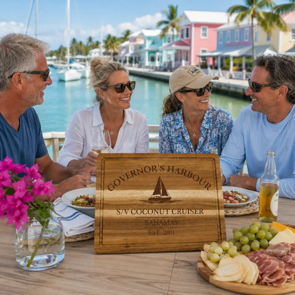 Governor’s Harbour Bahamas personalized cutting board being enjoyed during a relaxed waterfront gathering with sailors and coastal family near the harbor in Eleuthera